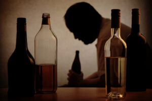 a-man-holding-an-alcohol-bottle
