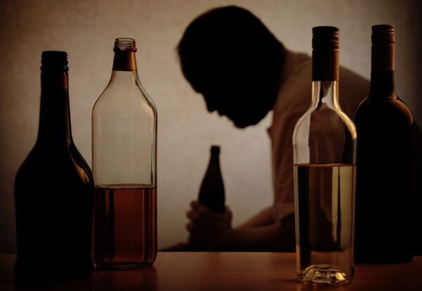 a-man-holding-an-alcohol-bottle